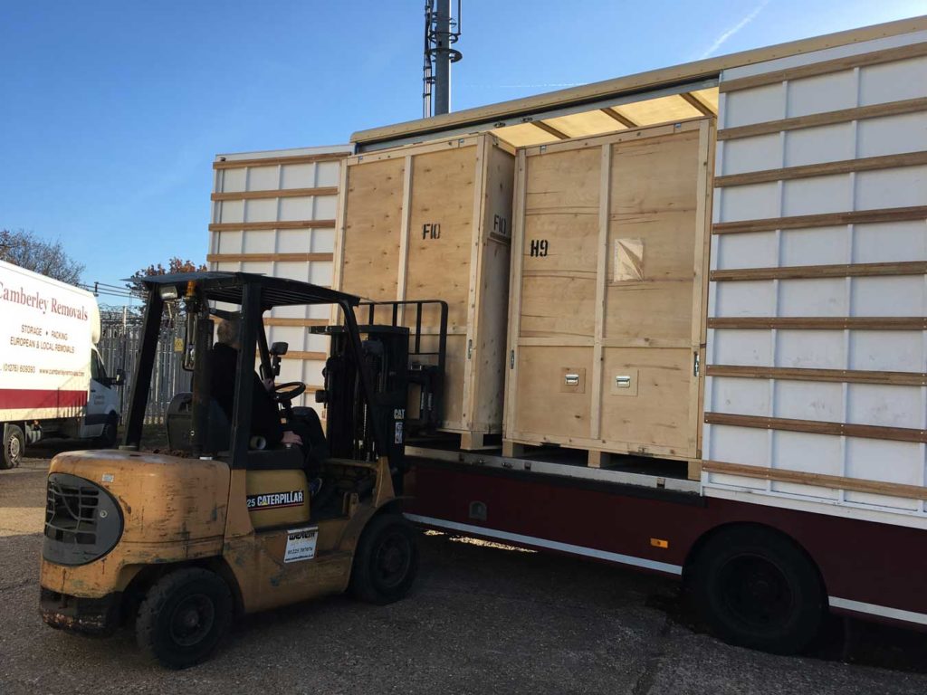 Forklift unloading storage crates for the warehouse