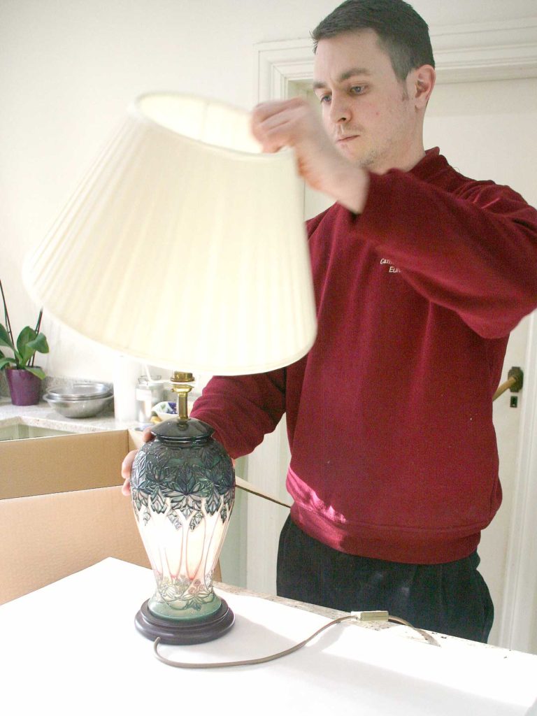 Camberley Removals packing expert preparing lamp for transit