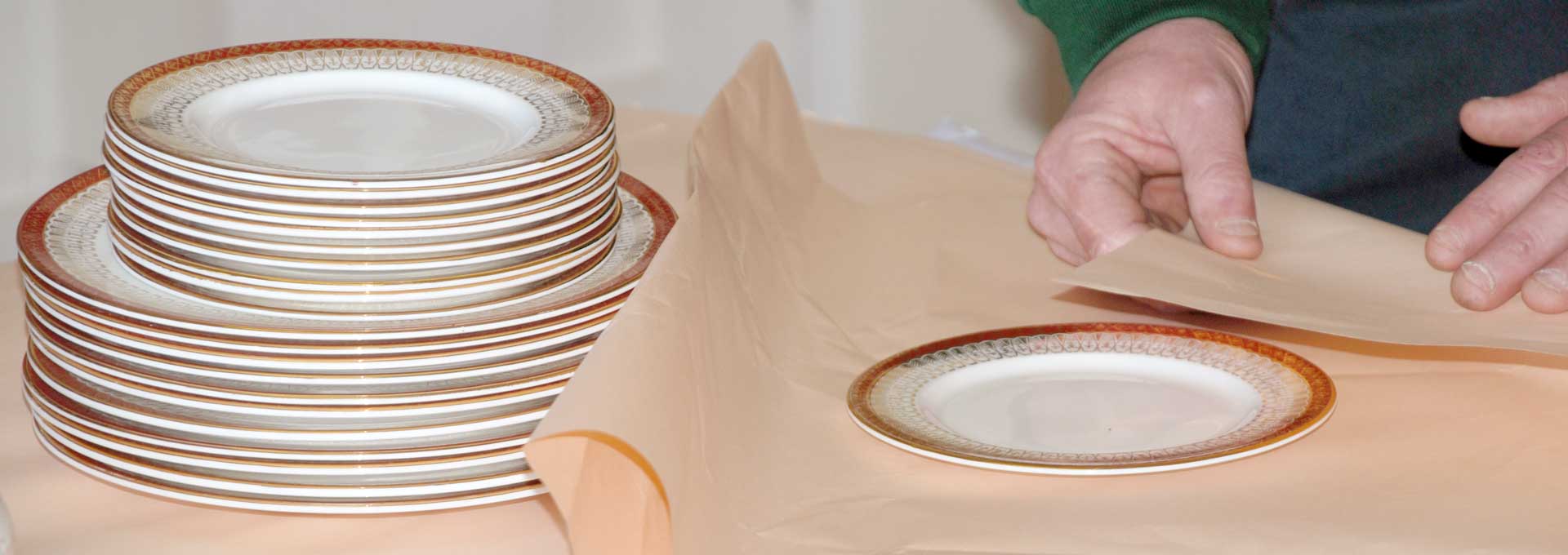 Camberley Removals expert carefully packing china plates